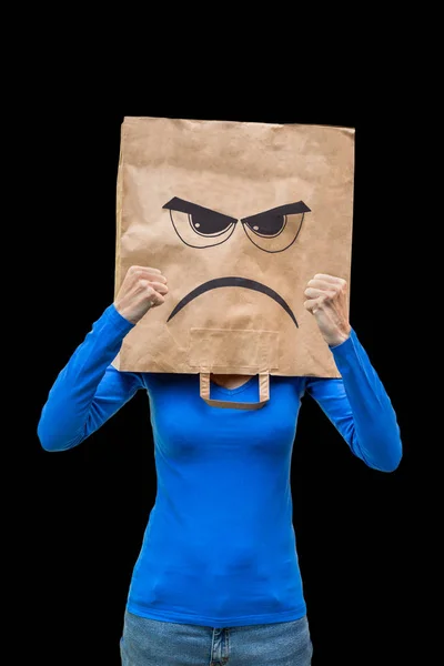 Woman wears paper bag with angry face on black  background — Stock Photo, Image