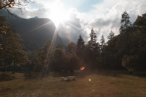 Gün batımında dağlarla dolup talan edilmiş güzel bir vadide piknik alanı veya yer