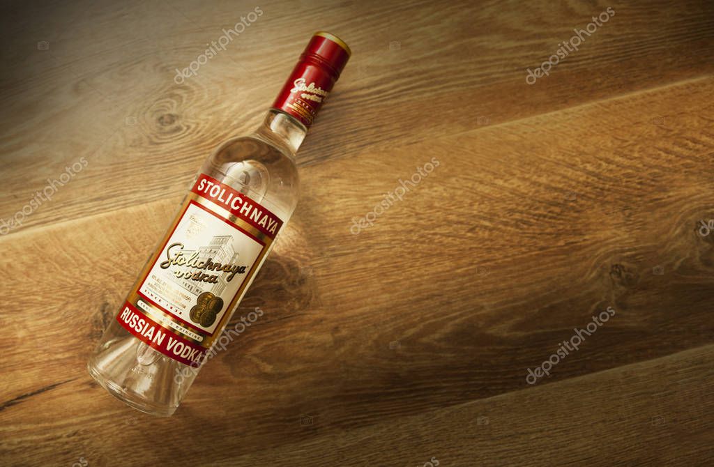 Chisinau, Moldova 18 June 2018: A bottle of Stolichnaya vodka on an wooden background. Russian traditional alcoholic beverage, produced in Russia at Cristal enterprises