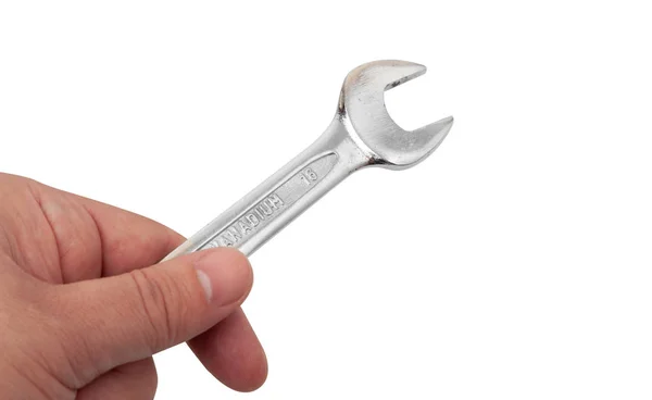 Close-up tiro de uma mão segurando uma chave, isolado em branco — Fotografia de Stock