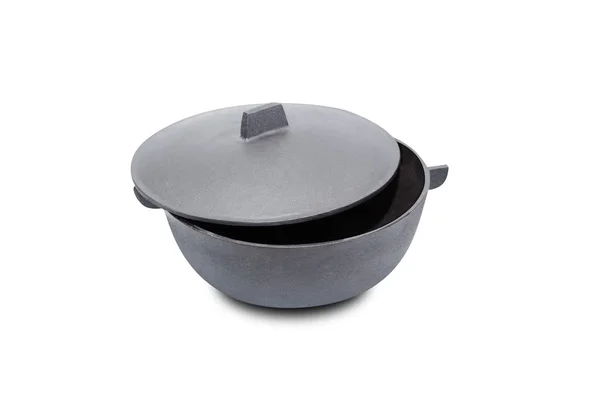 Large black cast iron pan with opened lid on white background — Stock Photo, Image