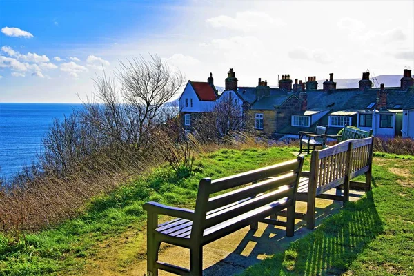 Capturing the atmosphere of a beautiful seaside town, famous as an end point for the Coast to Coast walk and also part of the Cleveland Way, on a sunny late winter\'s day.