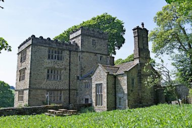 North Lees Hall, standing on a sweeping hillside beneath Stanage Edge, is set amidst some of the most spectacular scenery of the Peak National Park. It provided the inspiration for Thornfield Hall, in Bronte's Jane Eyre. clipart