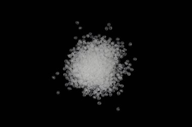 Concept Natural plastics Love the world. Polymer pellets Isolated on black background. Innovation natural plastic. clipart
