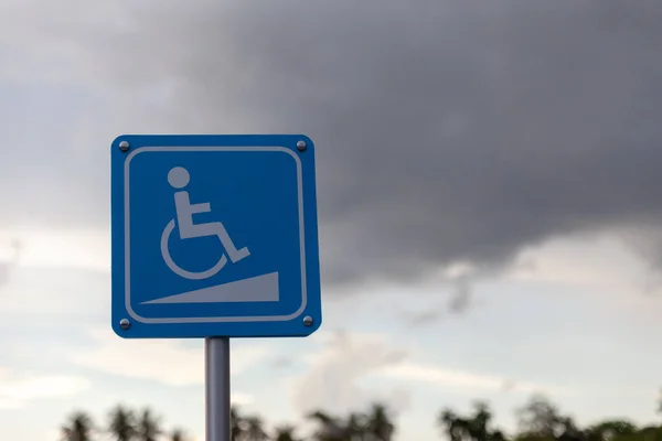 Handicap sign on sunset background.