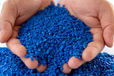 Blue plastic grain, plastic polymer granules,hand hold Polymer pellets, Raw materials for making water pipes, Plastics from petrochemicals and compound extrusion, resin from plant polyethylene. clipart