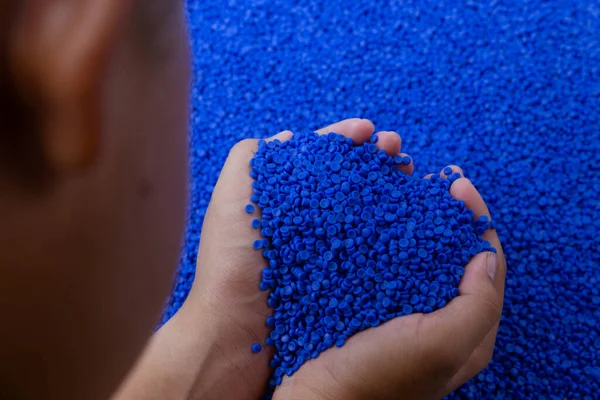 Close-up of plastic polymer granules. hand hold Polymer pellets. polymer plastic. compound polymer.
