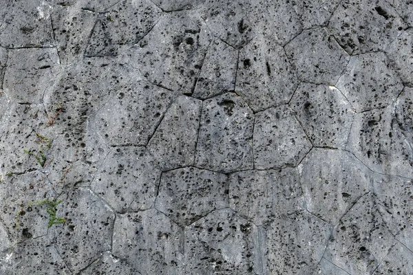 Granit duvar, pürüzsüz yüzey, arka plan için koyu gri. Güçlü granitten yapılmış şehir duvarı