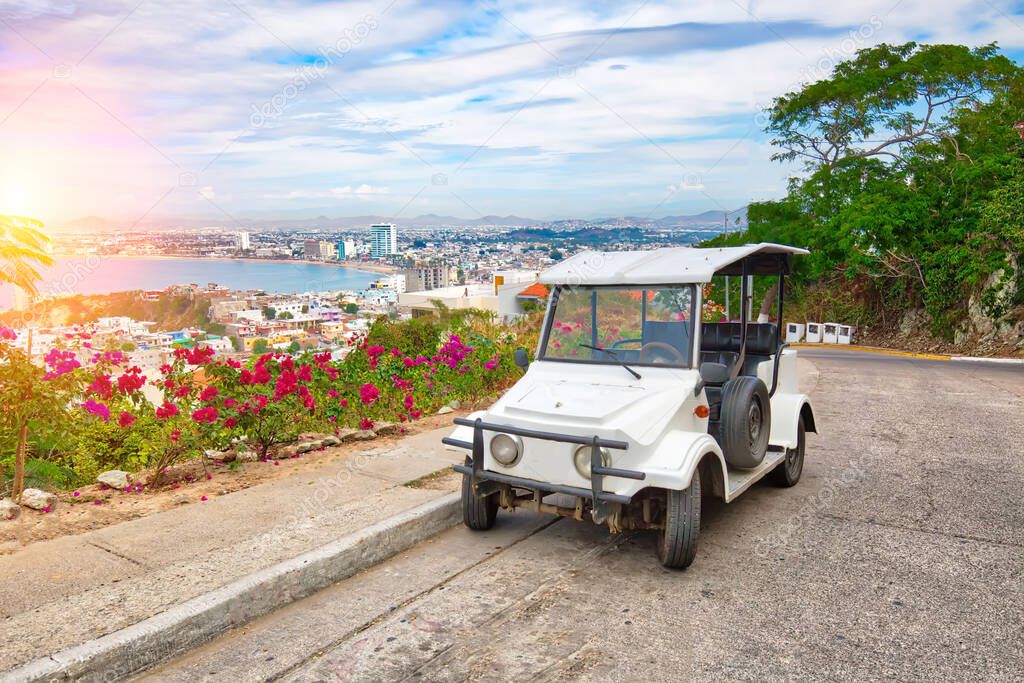 Pulmonia taxi with panoramic view of the Mazatlan Old City in the background, Mexico
