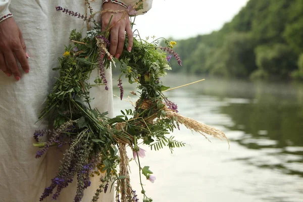 Дівчина в Слов'янському одязі з вінком на фоні ріки Ліцензійні Стокові Фото