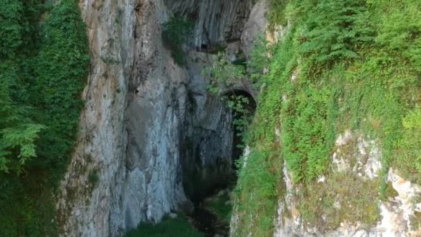Aerial View of Entrance to Potpec Cave, Serbia. Horseshoe Opening and Stream — Stock Video