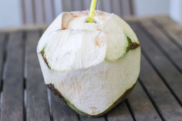 Fresh coconut drink with a straw — Stock Photo, Image