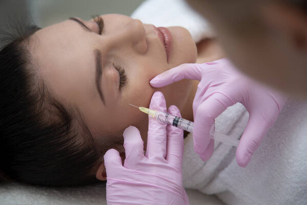 Beauty injections into beautiful face. smoothing of mimic wrinkles around the eyes using biorevitalization