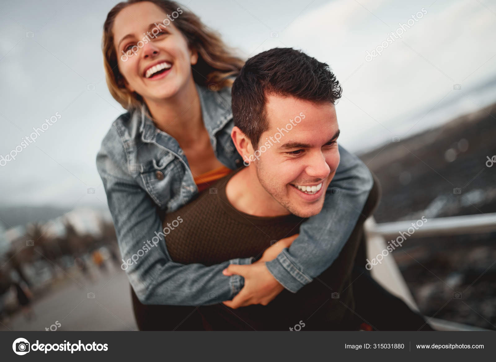 Young Man Giving Woman Piggyback Outdoors, Stock image