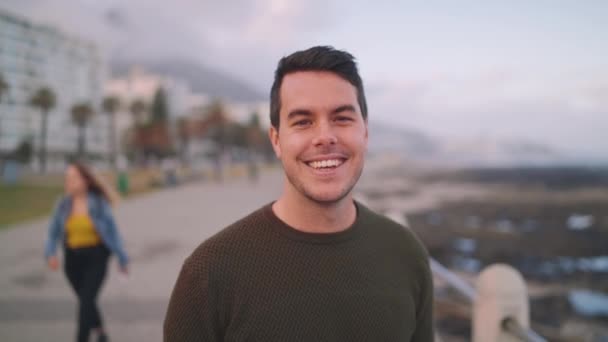 Portrait of a happy handsome young cool trendy man in a urban street smiling and looking at camera — Stock Video