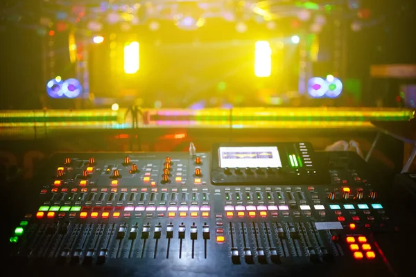 Music mixer with stage, concert background blurred, yellow light — Stock Photo, Image