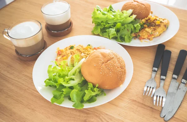 Breakfast Omelette Burger Salad served with coffee.