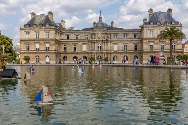 Paris, Fransa - 5 Ağustos 2014: Paris'teki Jardin du Luxembourg parkında insanlar, tekneler ve sarayla rahat sahneler