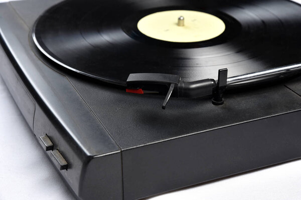 Old vinyl record player on white background.