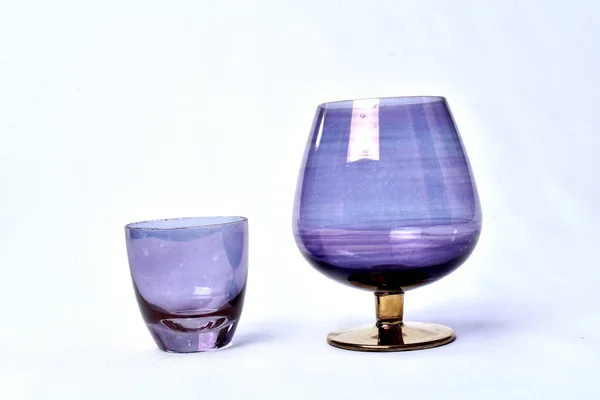 Színes italok üveg csésze asztal, fehér háttér — Stock Fotó