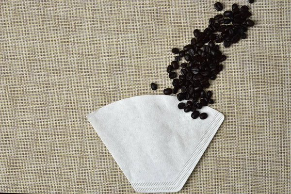 Roasted coffee bean and paper colander — Stock Photo, Image
