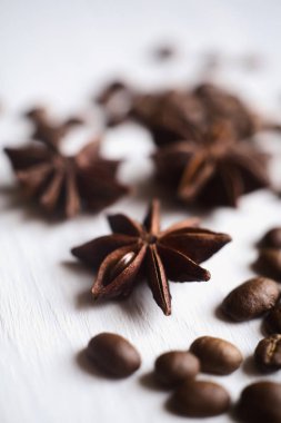 Beyaz arka plan üzerinde yakın çekim yıldız anason ve kahve çekirdekleri