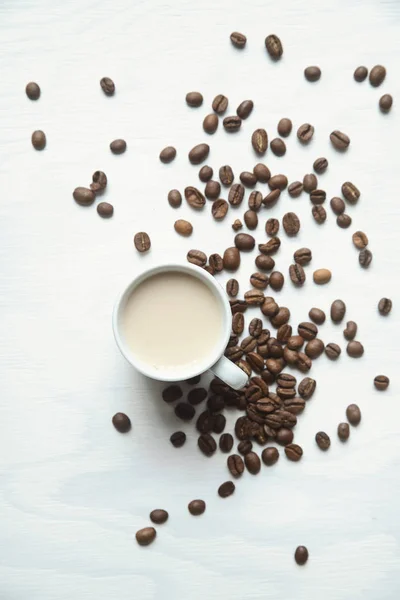 Flatlay coffee cup and coffee beans on a white background Royalty Free Stock Images