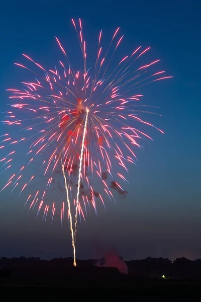 Fourth of July fireworks over small town America.  Peru, Illinois, USA