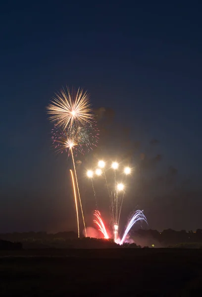 Fourth of July fireworks over small town America.  Peru, Illinois, USA