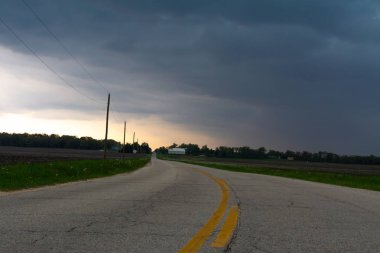 Kırsal Illinois yaklaşan fırtına bulutları ile açık ülke yolu.