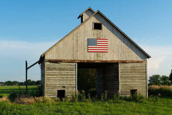 Old wooden barn with American Flag