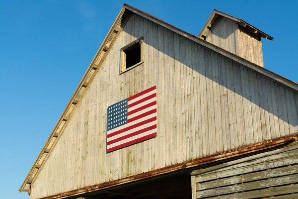 Old wooden barn with American Flag