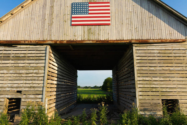 Old wooden barn with American Flag