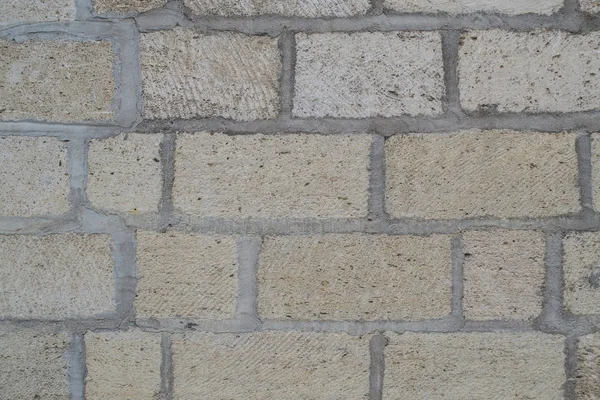 Kumlu renk eski tuğla duvar. Doku, arka plan