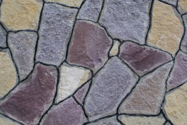 Doku. Çok renkli taş duvar. Arka plan