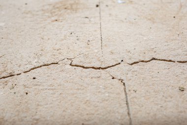 Cracks in the concrete cement screed on the floor after repair. The concrete surface texture is covered with web cracks. Gray stone background clipart