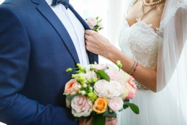 Yeni evlilerin elinde güzel bir buket çiçek.