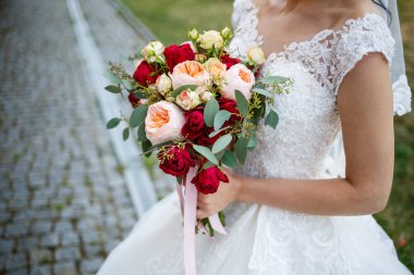 Yeni evlilerin elinde güzel bir buket çiçek.