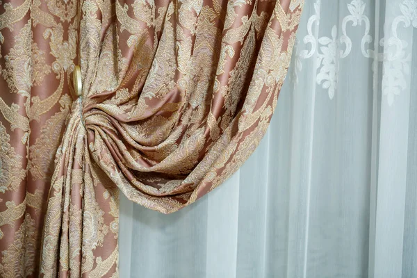 Close up of a curtain. part of the drapery by the window. Tulle for windows