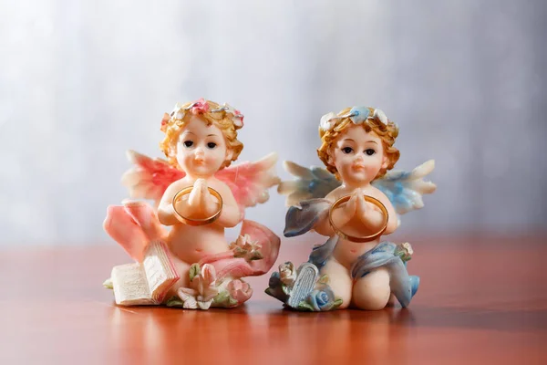 Ceramic angels. Figurines angels. Gold wedding rings