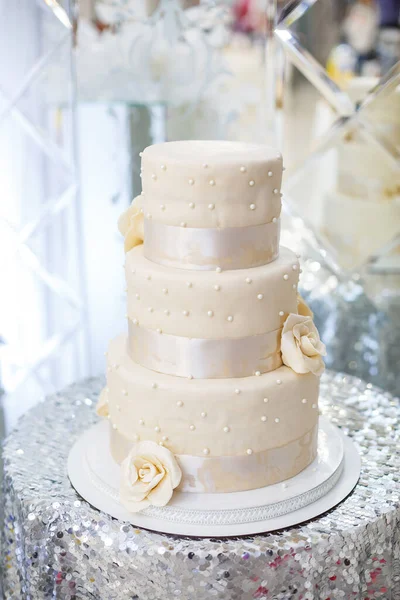 White cake with three tiers with cream