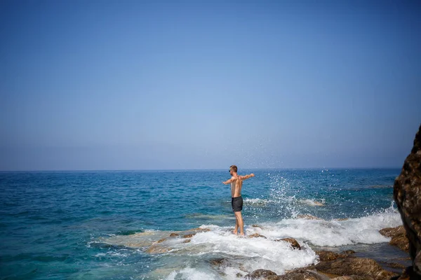 Ένας Νεαρός Άνδρας Στέκεται Στους Βράχους Θέα Την Ανοιχτή Μεσόγειο — Φωτογραφία Αρχείου