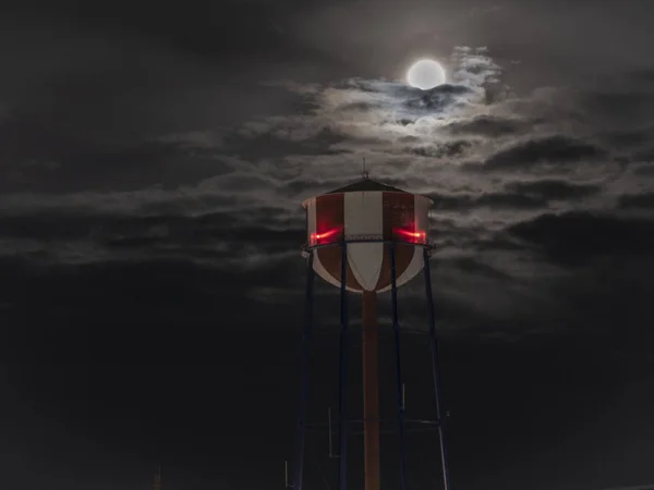 Idaho Falls water tower with a full moon