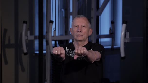 Чоловік віку виконує спільну гімнастику для пальців в тренажерному залі. — стокове відео