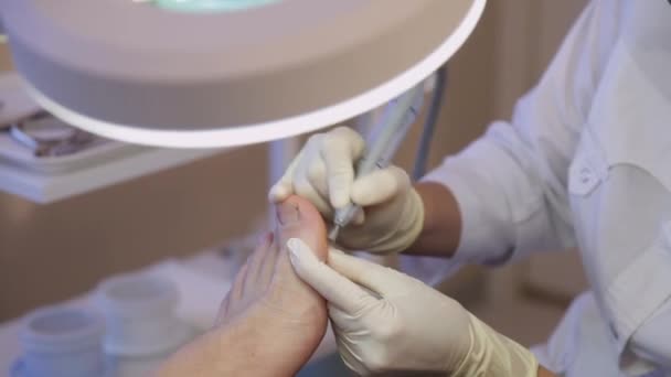 Подолог лікує пацієнтів великим пальцем ніг.Подологія.Посуд педикюр — стокове відео