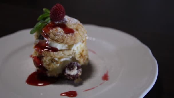 Raspberry Millefeuille on a white plate. Napoleon cake. The camera moves around this to the left — Stock Video
