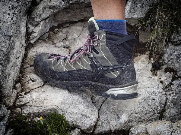 Trekking boot on a rock detail