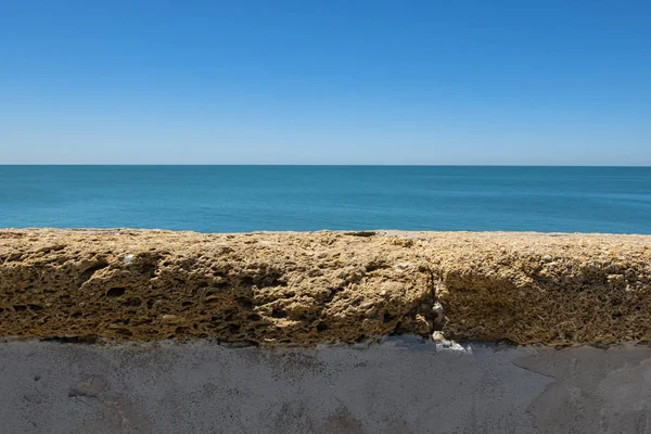 Landscape of the sea behind a wall