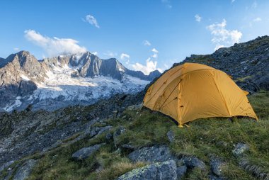 Hiking tent in the italian alps clipart