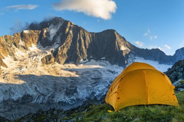 Hiking tent in the italian alps clipart